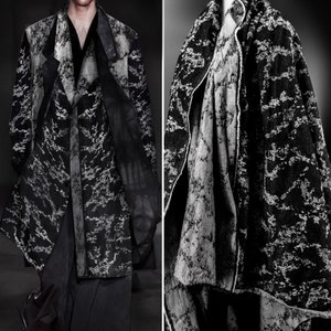 May include: Two black and white patterned jackets with a textured, abstract design. The jackets are made of a soft, flowing fabric.
