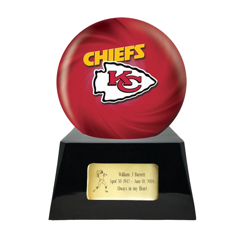 May include: A red and white Chiefs bowling ball trophy. The ball features the team's logo and the word "CHIEFS" in yellow. The black base has a gold plaque with a football player illustration and the inscription: "William J Barrett April 30, 1942 - June 01, 2004 Always in my Heart."
