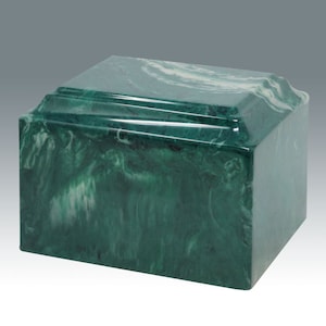 May include: A green marble cremation urn with white swirling patterns. The urn has a rectangular shape with rounded edges.
