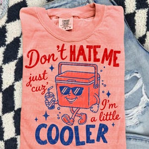 Don’t Hate Me, I’m Cooler
Comfort Colors 1717 Tee
Multiple Shirt Colors Available
Funny Summer Graphic Tee
Lake Day + Boat Day Ready
Perfect for Camping Trips
Cute Gift for Summer Girls