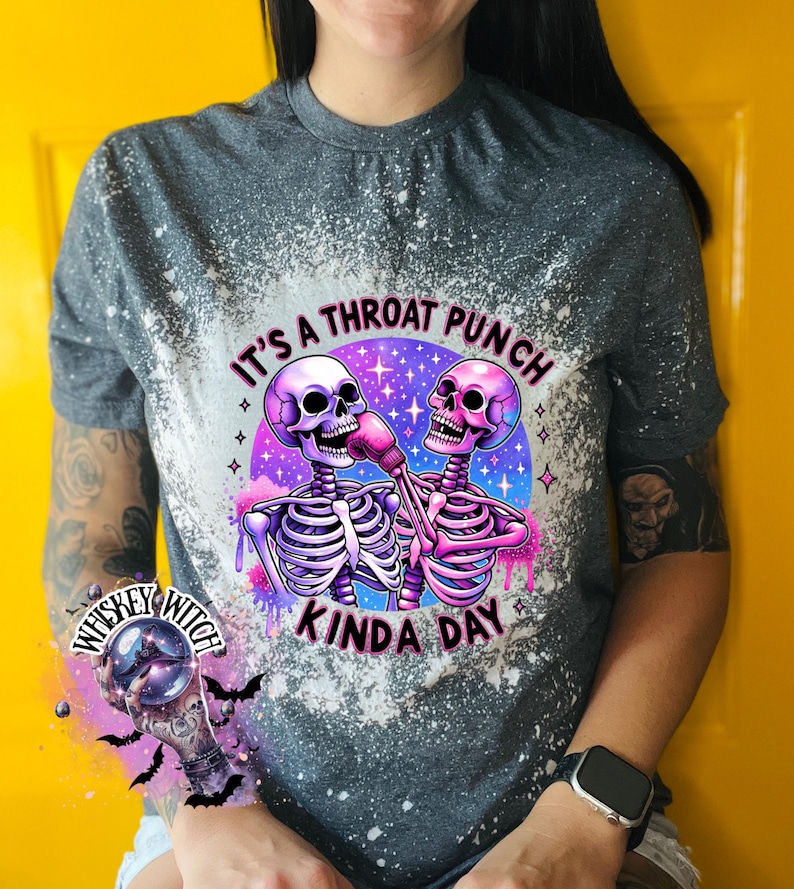 May include: A gray t-shirt with a bleach-splattered design featuring two skeletons wearing boxing gloves. The text "It's a throat punch kinda day" is printed on the shirt.