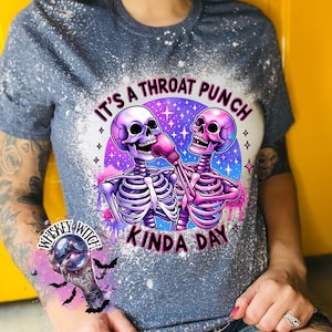 May include: A gray t-shirt with a bleach-splattered design featuring two skeletons boxing. The text "It's a throat punch kinda day" is printed on the shirt.