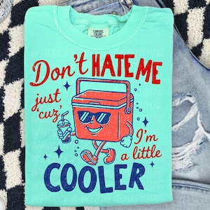Don’t Hate Me, I’m Cooler
Comfort Colors 1717 Tee
Multiple Shirt Colors Available
Funny Summer Graphic Tee
Lake Day + Boat Day Ready
Perfect for Camping Trips
Cute Gift for Summer Girls