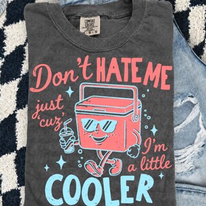 Don’t Hate Me, I’m Cooler
Comfort Colors 1717 Tee
Multiple Shirt Colors Available
Funny Summer Graphic Tee
Lake Day + Boat Day Ready
Perfect for Camping Trips
Cute Gift for Summer Girls