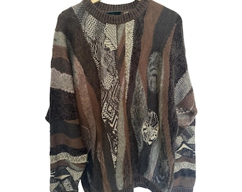 May include: A brown, beige, and gray patterned sweater with a crew neck.