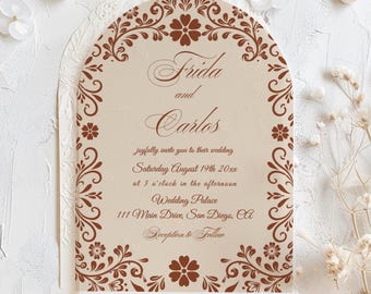 May include: A wedding invitation featuring a brown floral design and the names "Frida and Carlos". The invitation includes the wedding date, time, and venue: Wedding Palace, 111 Main Drive, San Diego, CA. The invitation is in an arched shape.