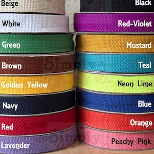 May include: Two stacks of woven cotton webbing ribbon in various colors including beige, white, green, brown, golden yellow, navy, red, lavender, black, red-violet, mustard, teal, neon lime, blue, orange, and peachy pink.