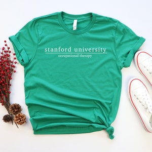May include: Green t-shirt with white text that reads "stanford university occupational therapy".