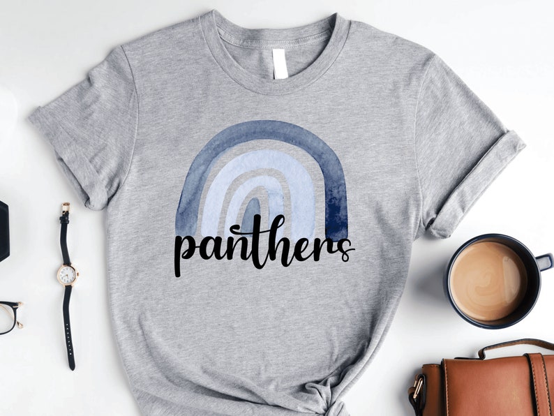 May include: A gray t-shirt with a blue watercolor rainbow and the word "panthers" in black lettering.
