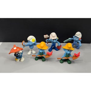 Vintage Rubber Smurf Figurines and one wind up Smurf