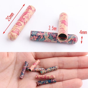 Puede incluir: Un conjunto de 8 tapones de extremo para cables o cordones de plástico, coloridos y con patrones. Los tapones de extremo miden aproximadamente 5 cm de largo y 4 mm de diámetro.