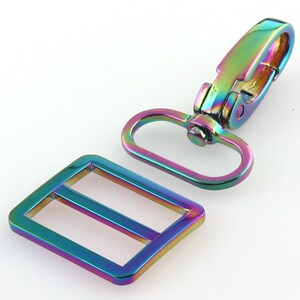 May include: A set of two iridescent metal hardware pieces for bags or other crafts. The set includes a rectangular slider buckle and a swivel hook.