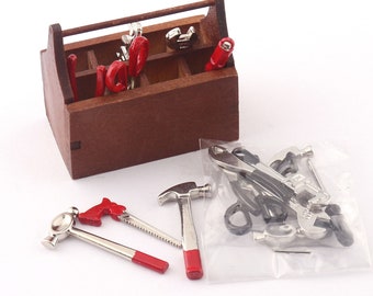 May include: A miniature wooden toolbox with a red handle, filled with miniature tools, including a hammer, saw, pliers, and screwdrivers. The tools are also packaged separately in a clear plastic bag.