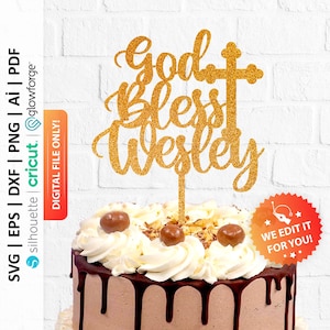 May include: Gold glitter cake topper with the words "God Bless Wesley" and a cross. The topper is on a chocolate cake with white frosting and chocolate drizzle.