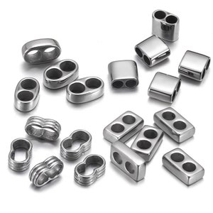 May include: A collection of silver-toned metal jewellery making supplies. The supplies include oval and rectangular double-hole connectors, and small, round, double-loop connectors.