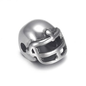 May include: A shiny, silver-colored football helmet charm. The charm has a detailed face mask and is designed to be a bead or pendant. The helmet is smooth and reflective, with a polished finish.