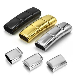 May include: An assortment of magnetic clasps in black, gold, and silver. The clasps are rectangular with rounded ends and a secure closure mechanism. The image also shows smaller silver clasp components.