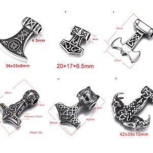 May include: Ten silver-toned pendants with intricate designs, including an axe, a hammer, and an anchor. The pendants are shown with their dimensions in millimetres.