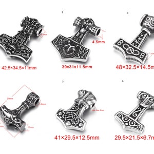 May include: Ten silver-toned metal pendants in the shape of a hammer with intricate designs. The pendants range in size from 7.5 cm to 12.2 cm in length.