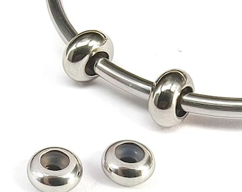 May include: Three silver-toned metal beads for a bracelet or necklace. The beads are round and have a smooth, polished finish. The beads are designed to be used with a bracelet or necklace that has a threaded core.