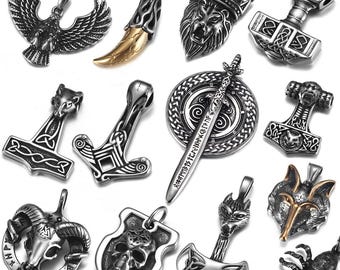 May include: A collection of 14 silver and gold pendants featuring various designs, including a lion, a skull, a wolf, a spider, a sword, and a variety of Norse symbols.