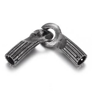 May include: Two silver-toned metal clasps with a ridged design. The clasps are connected together in a loop.
