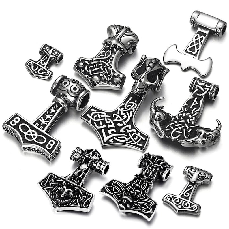 May include: A set of ten silver-toned metal charms featuring various Norse and Viking symbols, including a hammer, an anchor, and a skull. The charms are intricately detailed with knotwork and other decorative elements.
