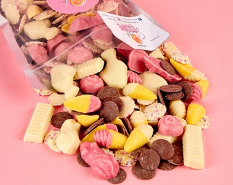 May include: A clear plastic bag filled with a variety of chocolate candies. The candies are in the shapes of fish, ice cream cones, and other fun shapes. The candies are white, pink, and brown. The bag is labeled "Sweet Escape" with a pink and white swirl design.