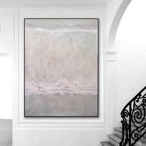 May include: A large abstract painting with a light gray background and subtle shades of purple. The painting has a textured surface and a horizontal line across the middle.