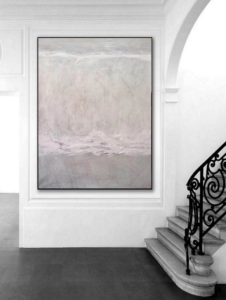 May include: A large abstract painting with a light gray background and subtle shades of purple. The painting has a textured surface and a horizontal line across the middle.