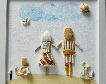 May include: A framed wall art piece featuring two figures and two animals crafted from various seashells and stones on a white canvas. The figures are holding hands, with blue painted clouds above and a gold painted ground below in a white frame.