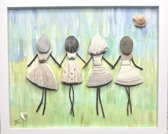 May include: A framed wall art piece featuring four figures created from seashells, pebbles, and twigs. The figures are holding hands against a painted background of light green and blue. A small shell is positioned in the upper right corner.