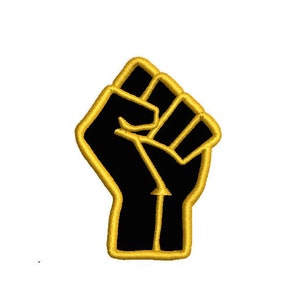 May include: Black fist raised in the air, outlined in gold. The fist is a symbol of strength and solidarity.