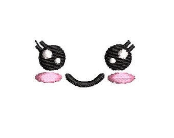 May include: A cartoon face with big black eyes, pink cheeks, and a smiling mouth. The face is embroidered with black and pink thread.