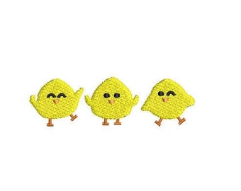 May include: Three yellow chicks with black eyes and orange beaks. The chicks are standing on a white background.