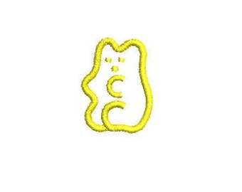 May include: A yellow gummy bear with a letter C on its belly.