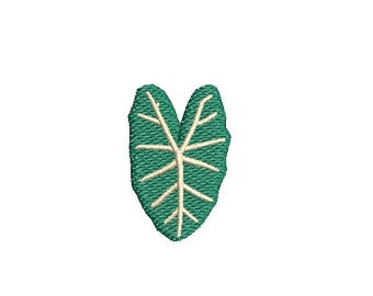 May include: A green embroidered leaf patch with a cream-colored vein pattern. The leaf is heart-shaped and has a textured appearance, suitable for clothing or craft projects.