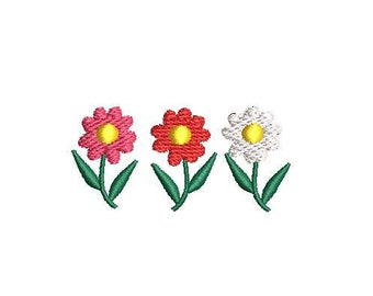 May include: Three embroidered flowers in a row. The flowers are pink, red, and white with yellow centers. The flowers have green stems and leaves.
