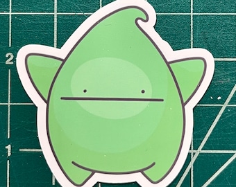 May include: A green cartoon character with a simple, friendly face. The character has a rounded body with two small arms and legs. The character is outlined in white.