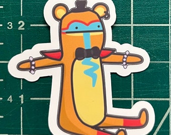 May include: A sticker of a cartoon animal wearing a bow tie and a top hat. The animal is orange, yellow, and red with a blue face. The animal has a lightning bolt on its chest.