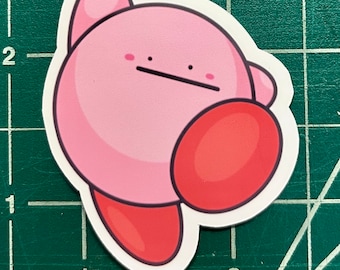 May include: Pink and red cartoon character sticker with a surprised expression. The character has a round body and a small, pointed nose.