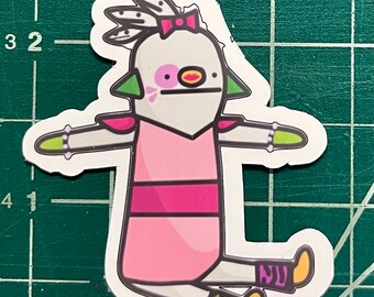 May include: A white, pink, and green cartoon character with a pink bow, green hair, and a pink dress. The character is sitting with its legs crossed and has a green and yellow polka dot sock on one foot and a purple and yellow sock on the other foot.