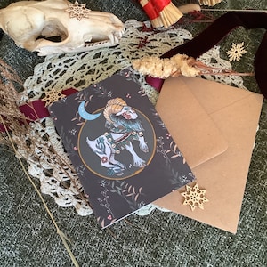 Tarjeta tamaño A6 adornada a mano con el libro de Navidad