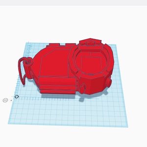 May include: A red 3D printed model of a device with a screen and buttons. The device has a loop on the side.