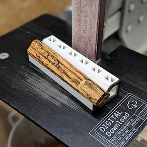 May include: A wooden handle bevel jig with a light brown and dark brown wood grain pattern is shown in a white holder. The jig is on a black surface with the text "DIGITAL Download" and other technical details.