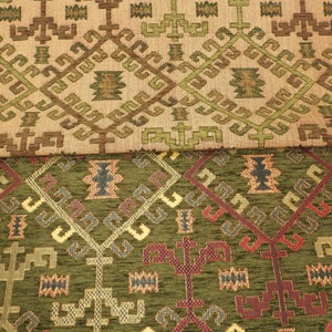 May include: Close-up of two fabric swatches with geometric patterns. The top swatch is beige with brown and green accents. The bottom swatch is green with brown, red, and blue accents.