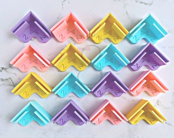 May include: A set of 15 colorful corner protectors with a bow design. The protectors are made of a soft, flexible material and are designed to protect furniture corners from bumps and scratches.