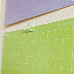 Puede incluir: Tapete de corte Cricut verde con un patrón de cuadrícula y el texto "StandardGrip" y "Cricut".