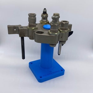 May include: A blue metal reloading tool with five different sized dies attached to a blue base with the text "FGS ENGINEERING" printed on it.