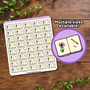 May include: A sheet of 63 stickers featuring a doodle of a closed journal with a flower and pencil. The text "Doodle Journals" is at the top of the sheet. The text "Multiple sizes available!" is in a purple circle with a larger doodle of the journal sticker.